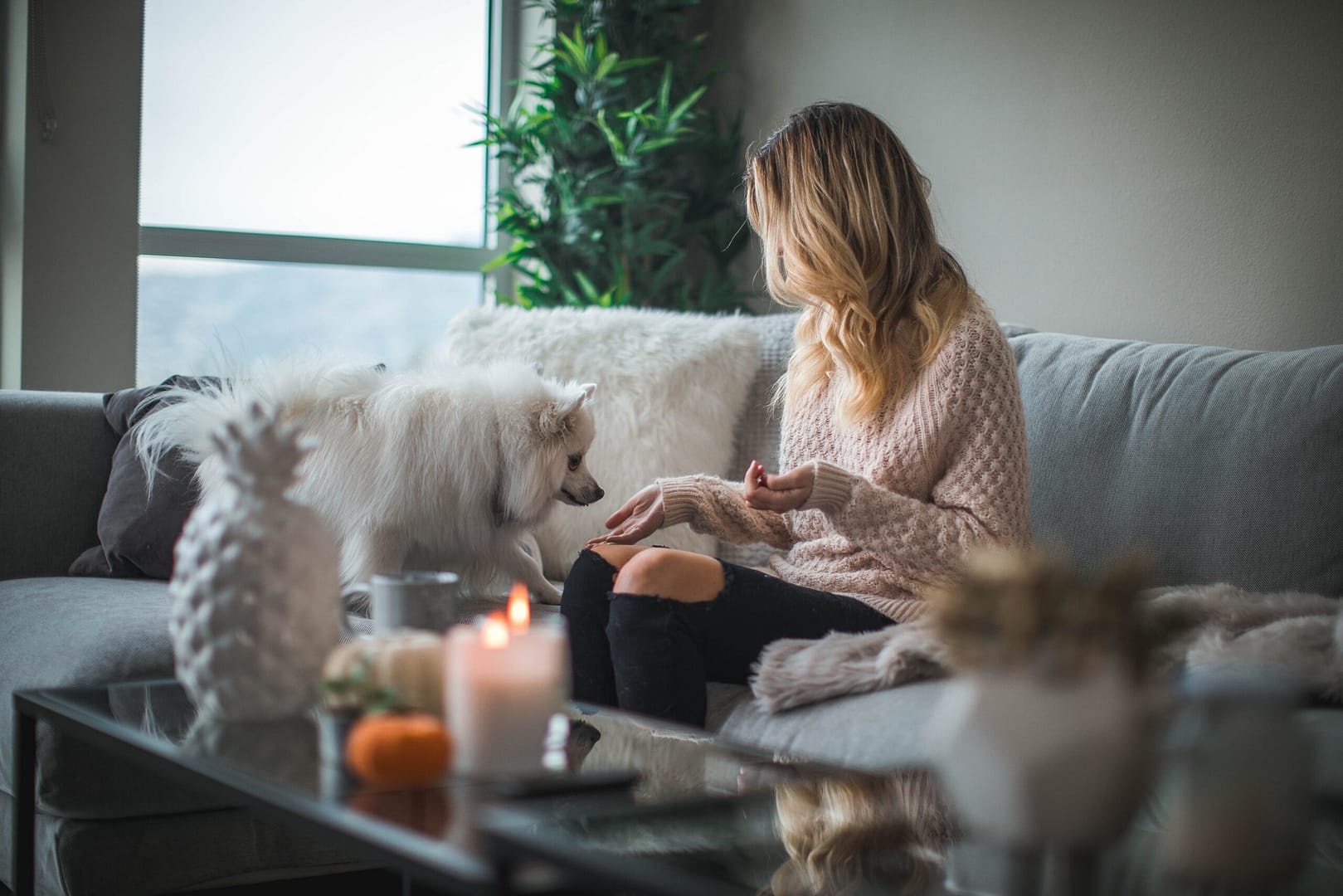 A cozy living room with warm colors, layered textiles, and a flickering fireplace, creating a welcoming winter haven