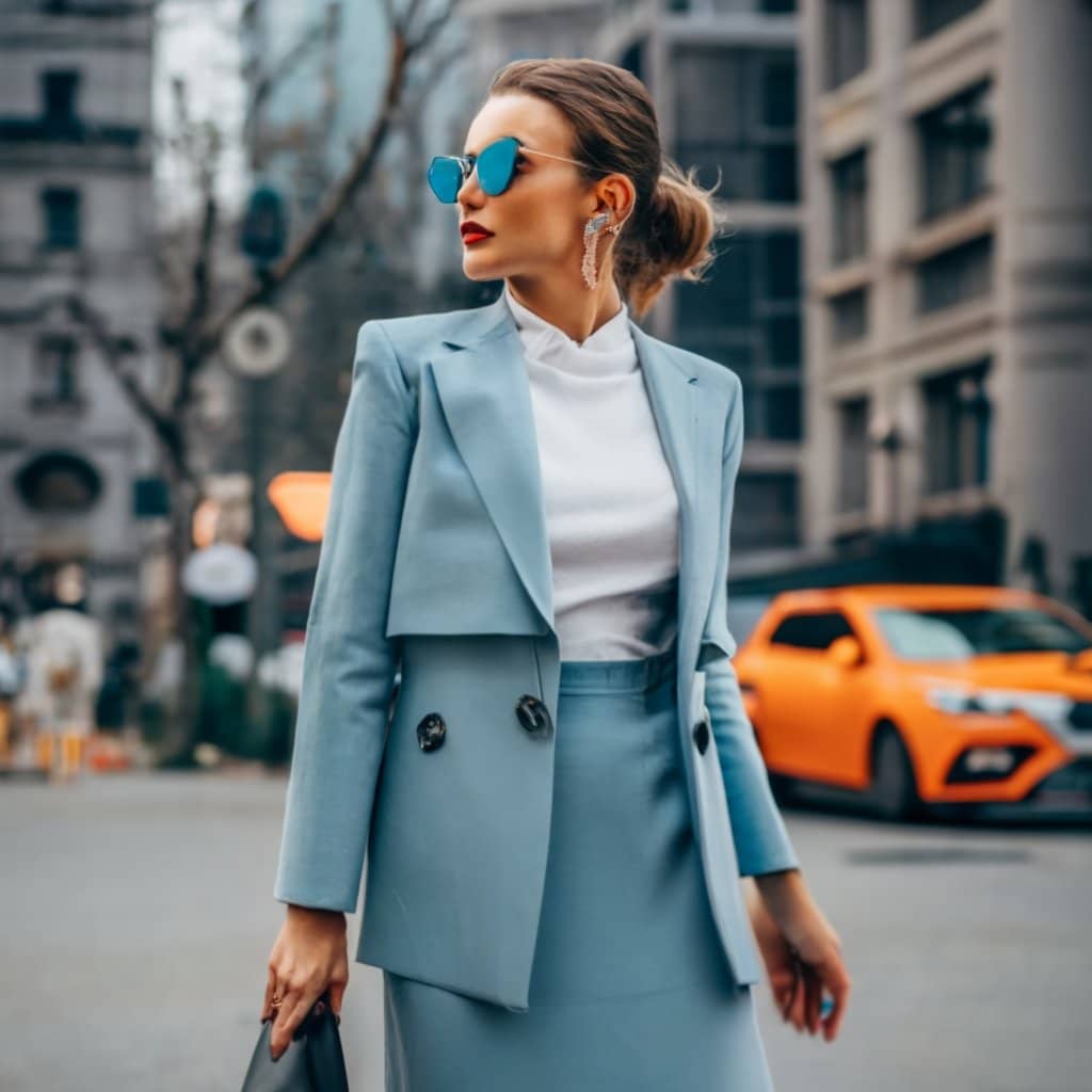 A fashionable girl wearing light blue skirt and